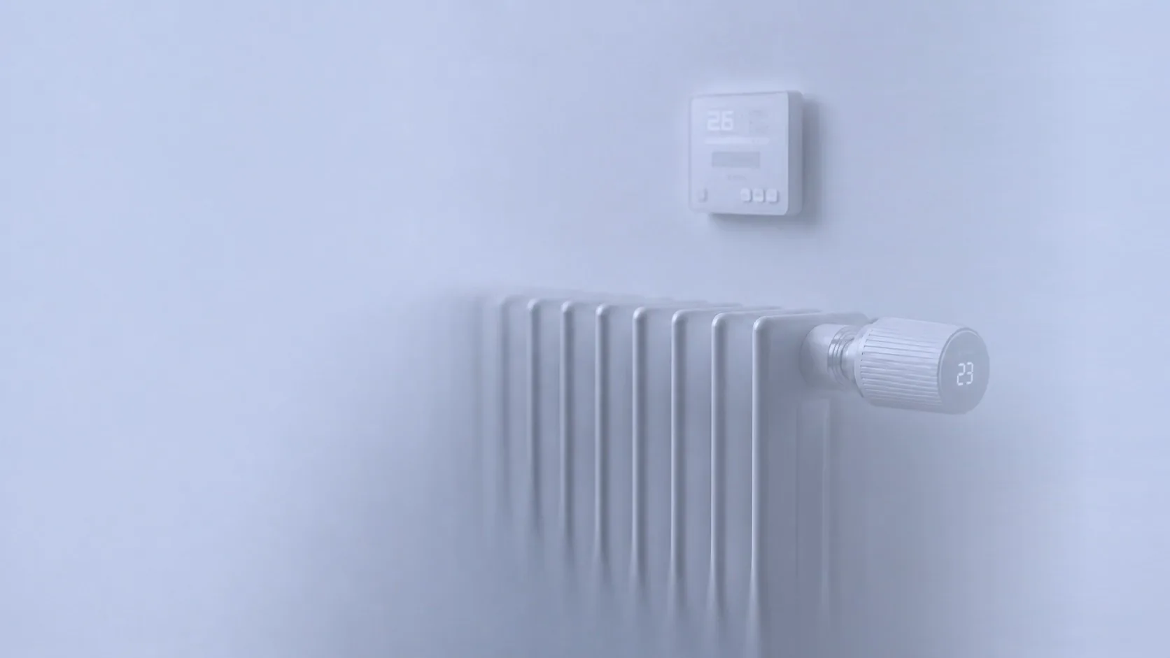 Translucent render of a radiator with a smart thermostatic valve and a wall thermostat